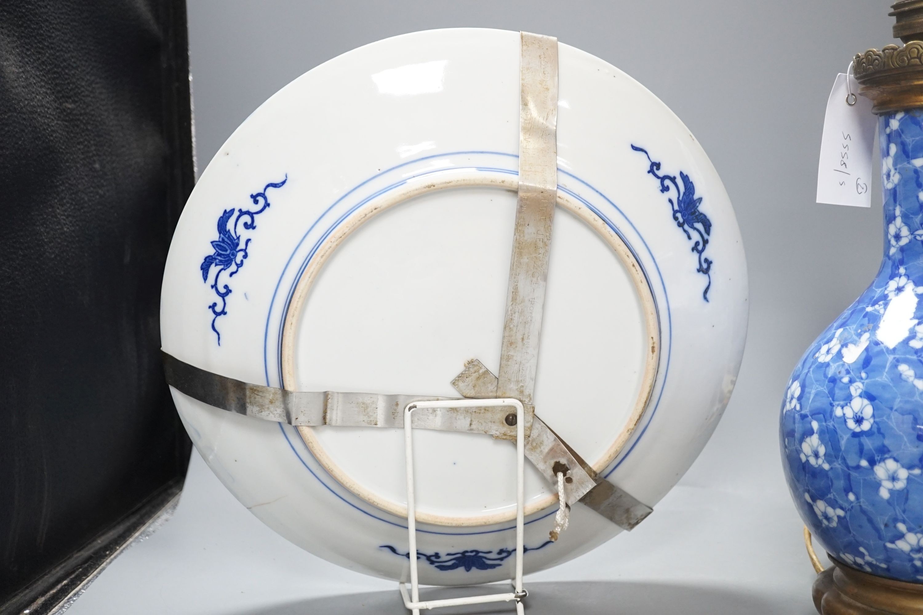 A Japanese prunus blue and white vase now as a lamp, together with a blue and white charger, 34cm diameter